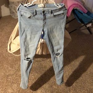 knee ripped blue jeans